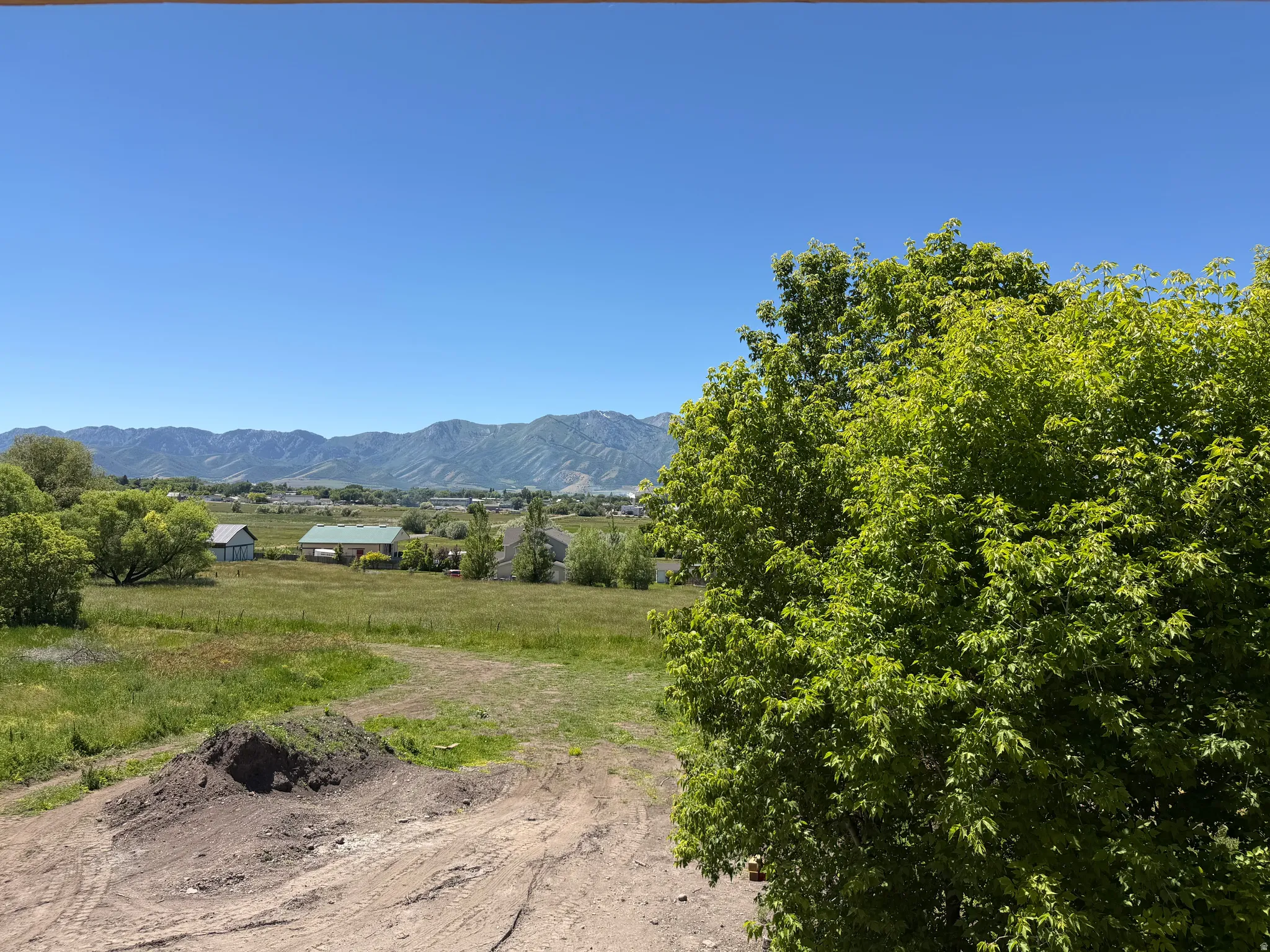 Expansive mountain range backdrop with a clear blue sky