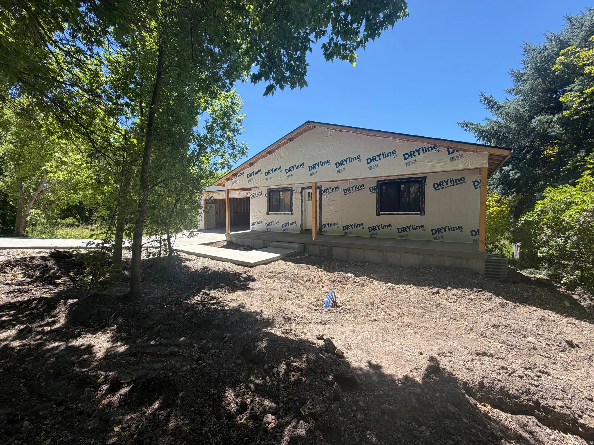 Single-story residence under construction featuring a gabled roofline and exposed wood framing