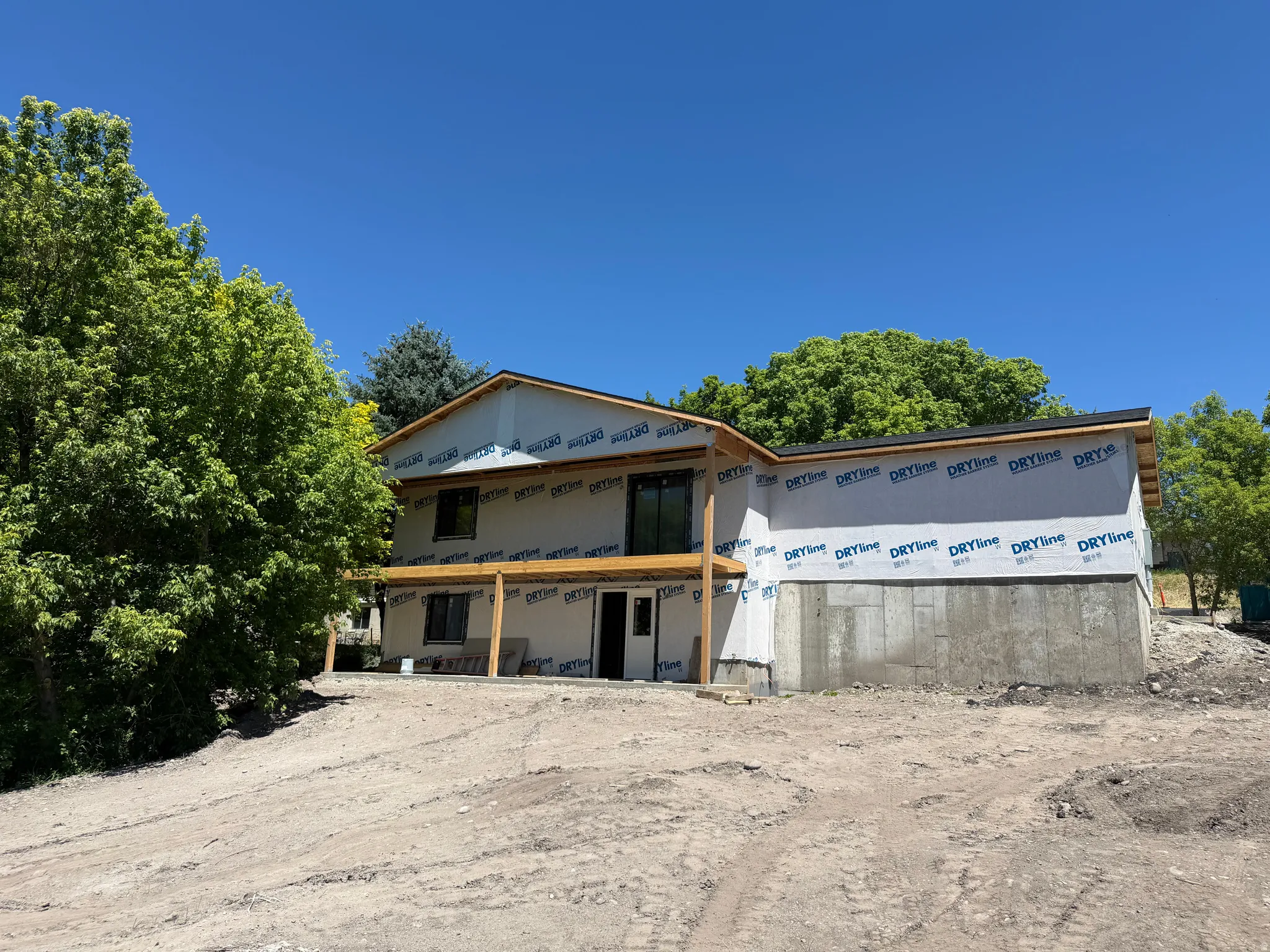 New construction opportunity featuring a concrete foundation, a partial second story, and a planned outdoor patio area