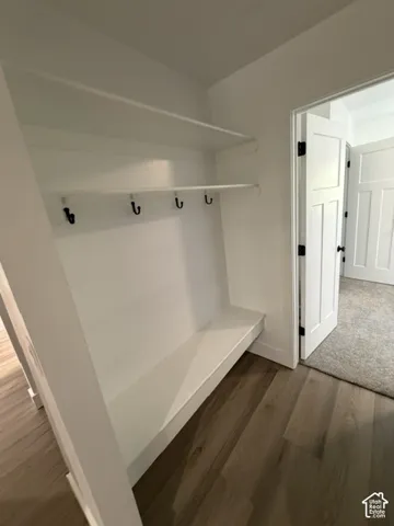 Built-in storage bench with upper shelving and coat hooks