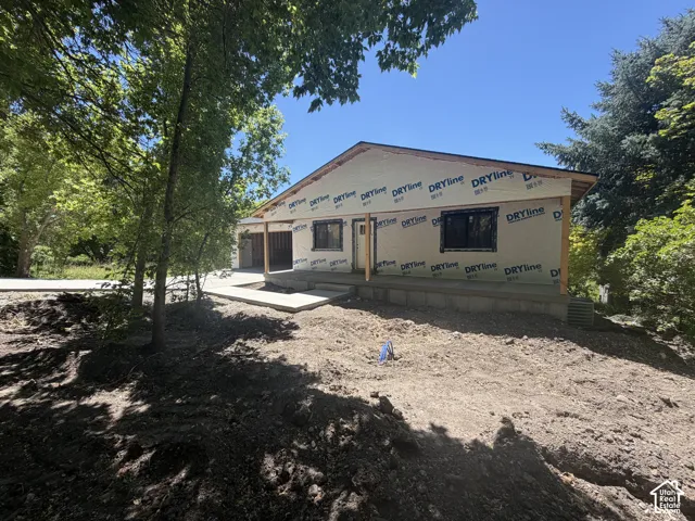 Single-story residence under construction featuring a gabled roofline and exposed wood framing