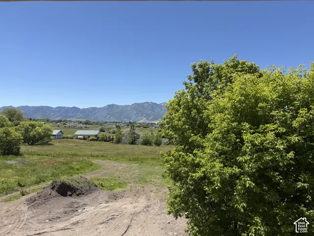 Expansive mountain range backdrop with a clear blue sky