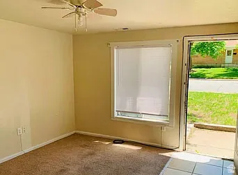 Living area featuring carpeted flooring and light-toned walls