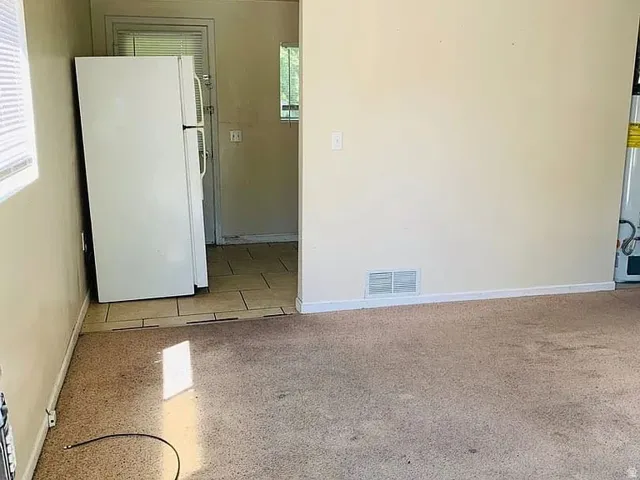 Carpeted flooring extending into a tiled area