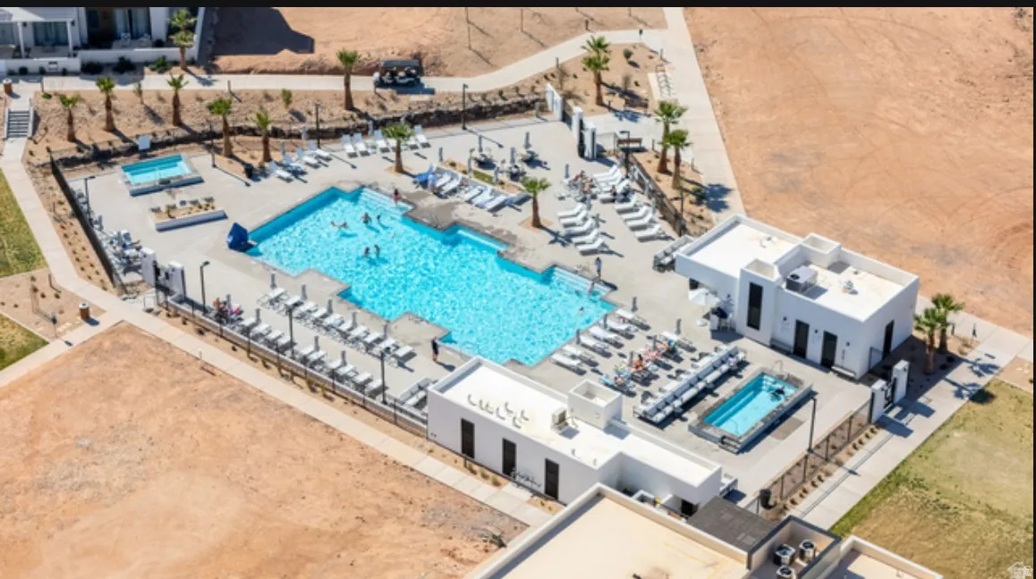 Resort-style pool area featuring a large swimming pool, separate rectangular plunge pool, and a dedicated spa