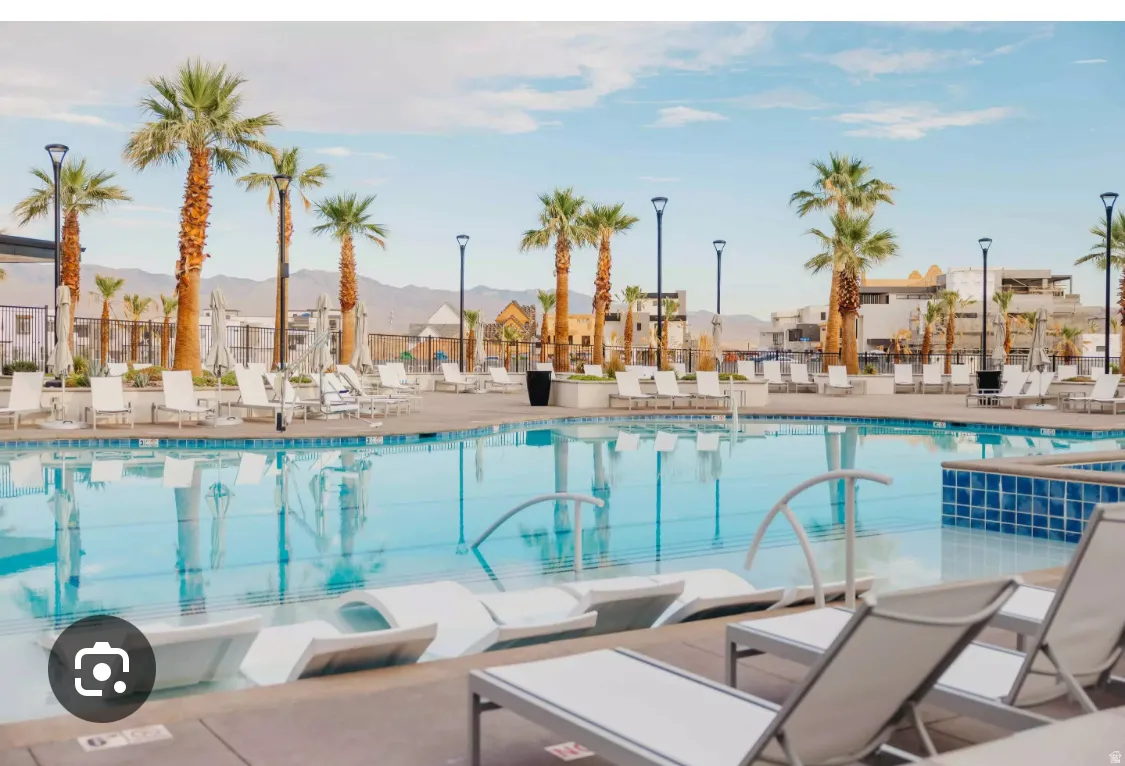 Expansive community pool area featuring a large, clear blue Lagoon  2.5 acre  swimming pool with integrated sun loungers Bring your paddleboards , Kayaks