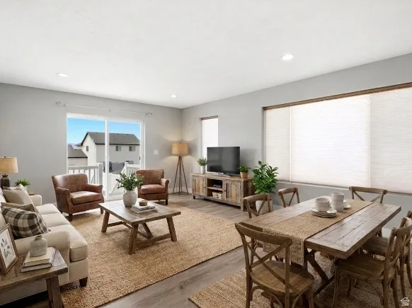 Open-concept living space featuring wood-finish flooring, recessed lighting, and light gray wall paint