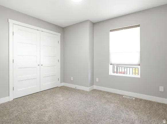 Neutral gray wall paint complementing a light-colored, textured carpet