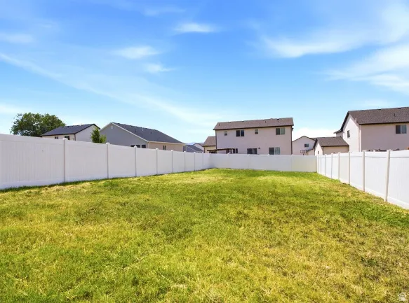 Expansive backyard with a full vinyl privacy fence