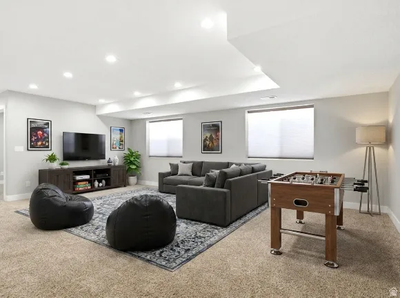 Spacious entertainment area with recessed lighting, light gray walls, and carpet flooring