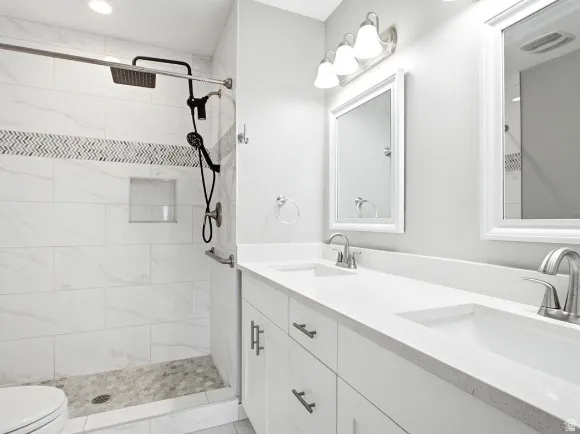 Modern bathroom featuring a double vanity with integrated sinks and white countertops