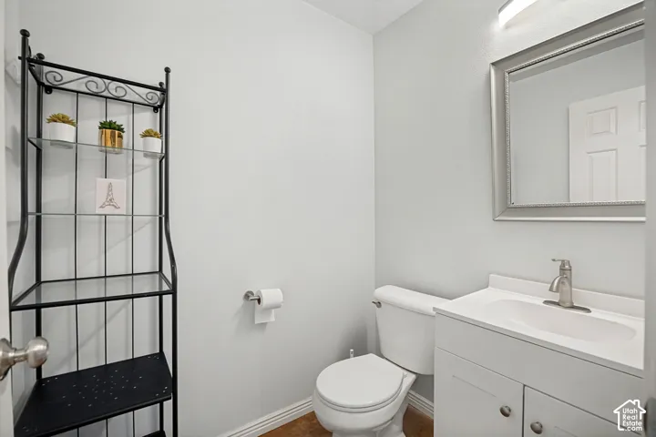 Bright vanity with integrated sink, brushed nickel faucet, and framed mirror
