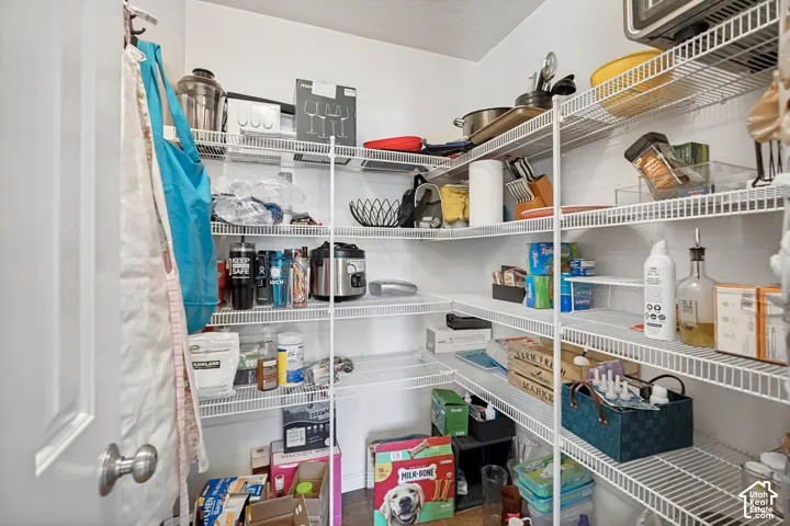 Walk-in pantry featuring white wire shelving providing ample storage