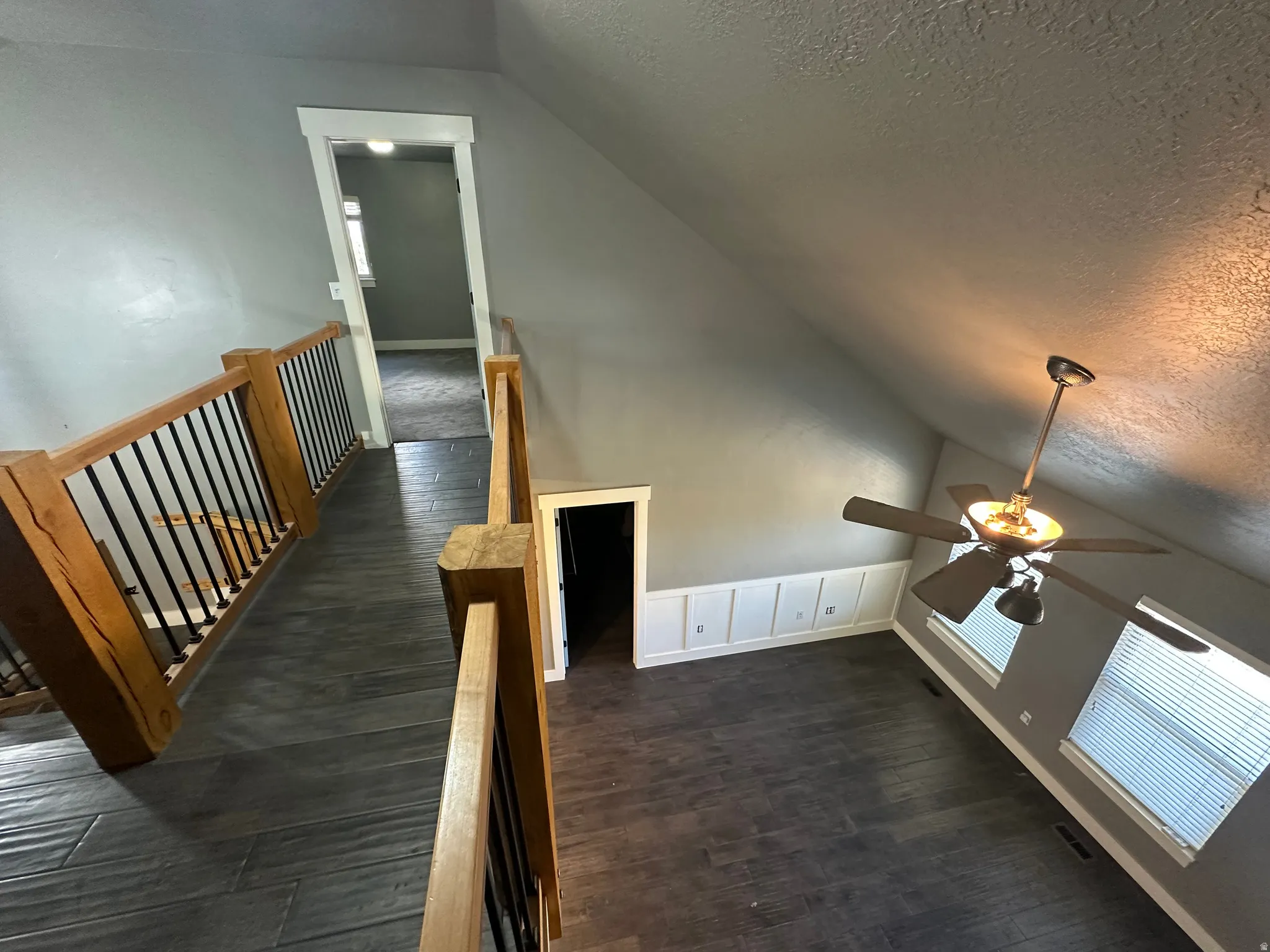 Vaulted ceiling interior with wood-finish flooring