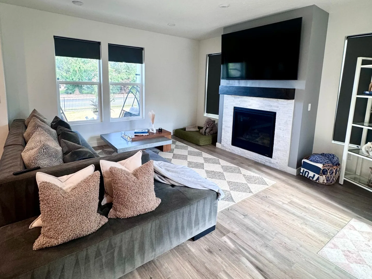 Living area featuring wood-finish flooring, recessed lighting, and a modern fireplace with a tiled surround