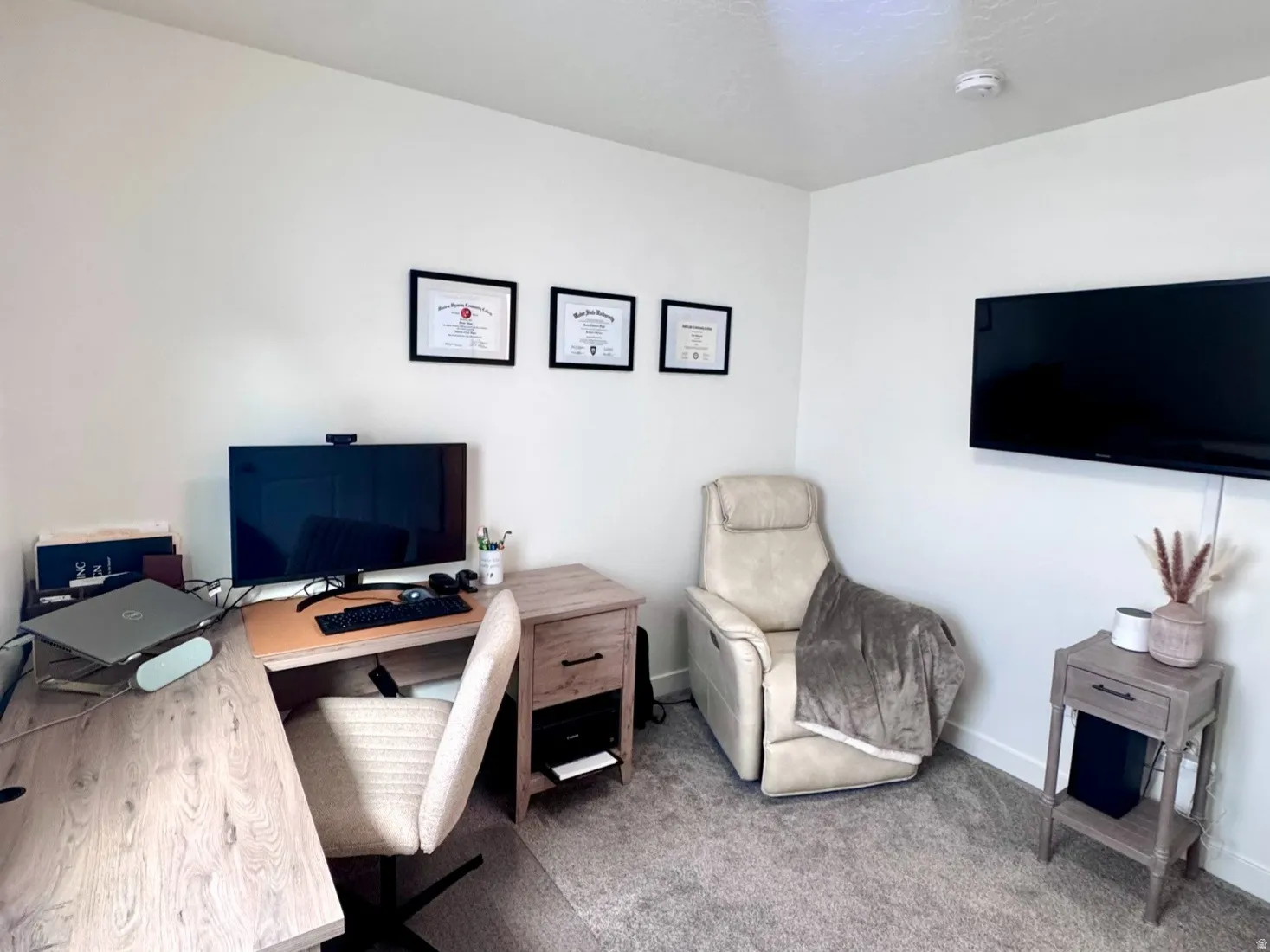 Neutral-toned wall-to-wall carpeting complements the white walls and ceiling
