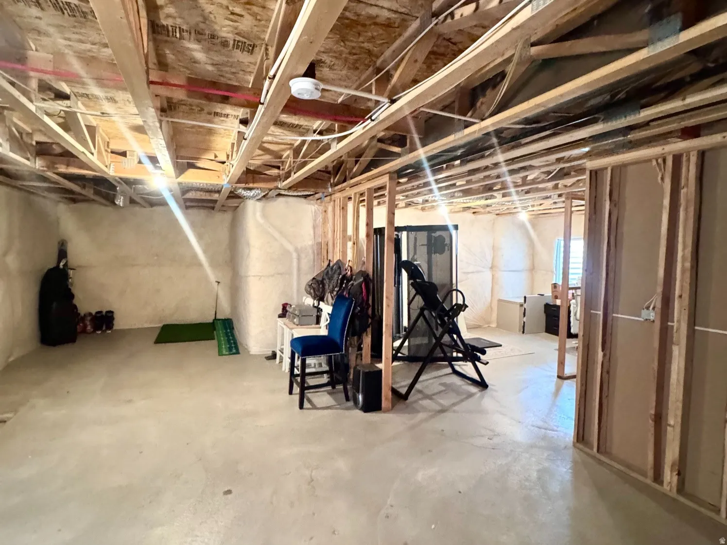 Lower level featuring exposed wood framing and concrete flooring