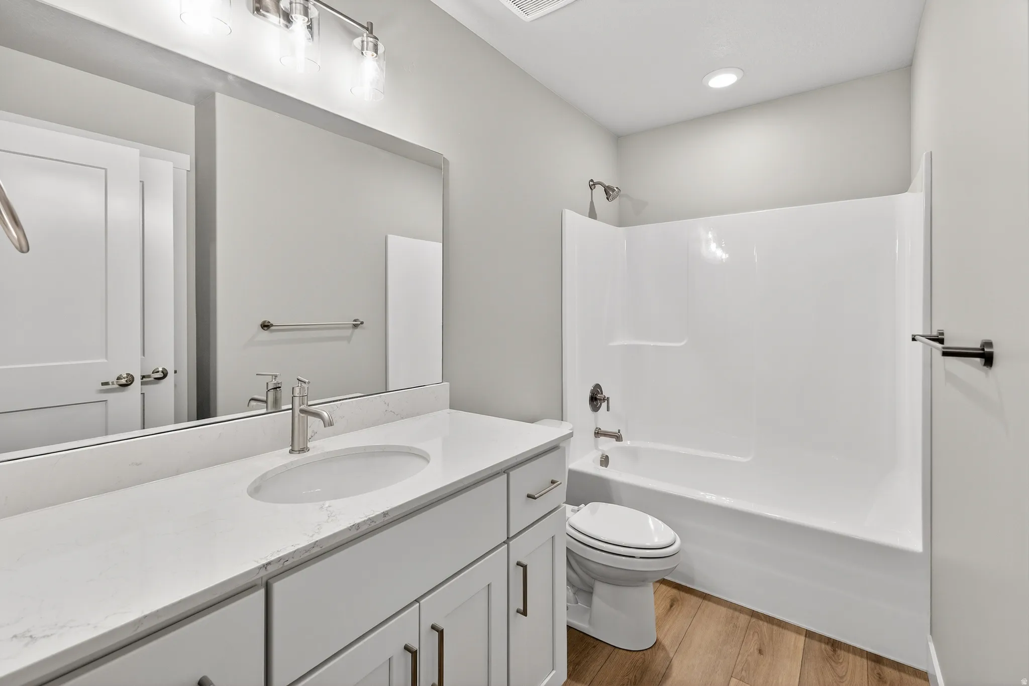 Bathroom featuring a white vanity with a light-toned countertop and an undermount sink