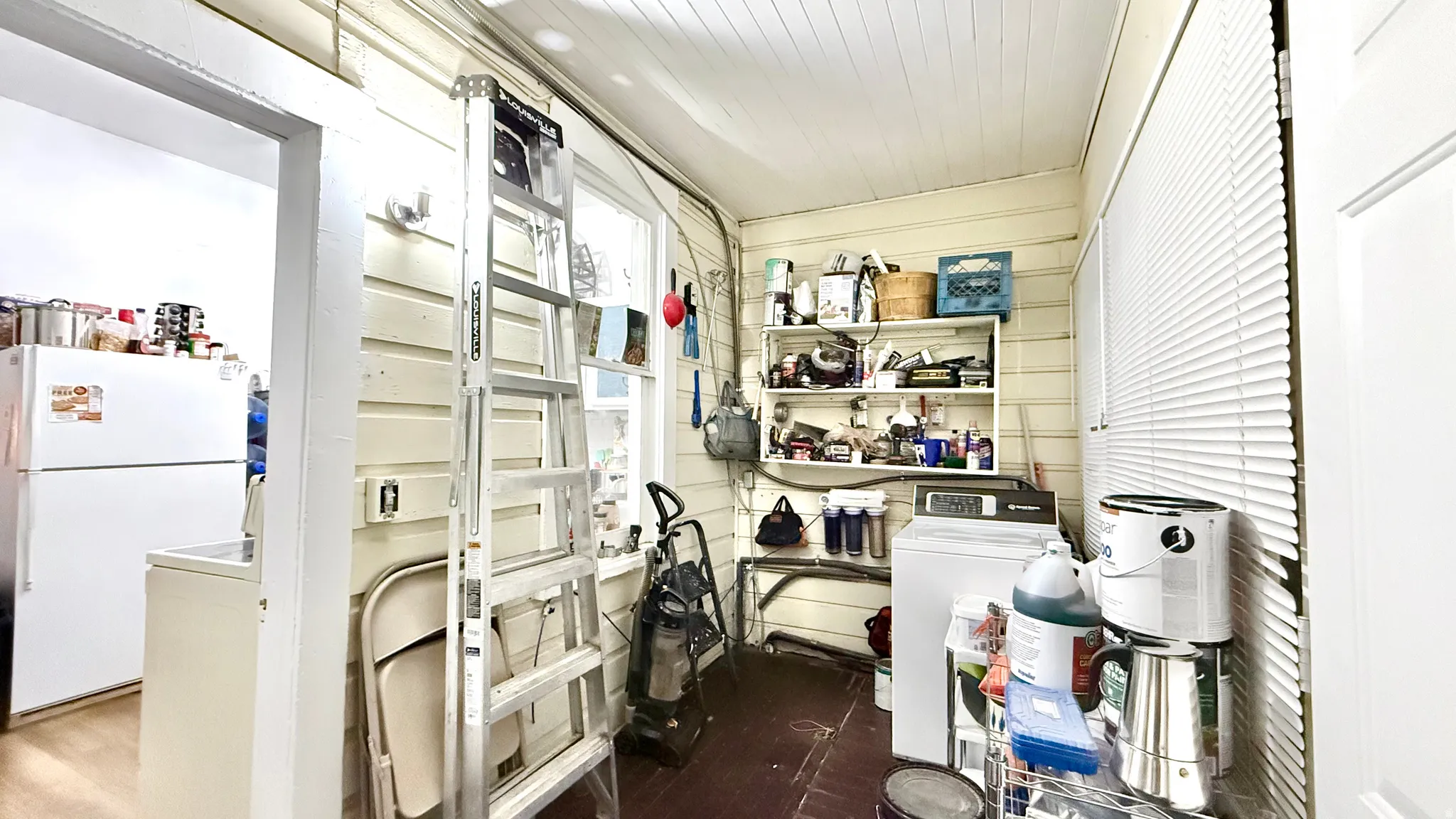 Utility area featuring horizontal wood paneling and a beadboard ceiling