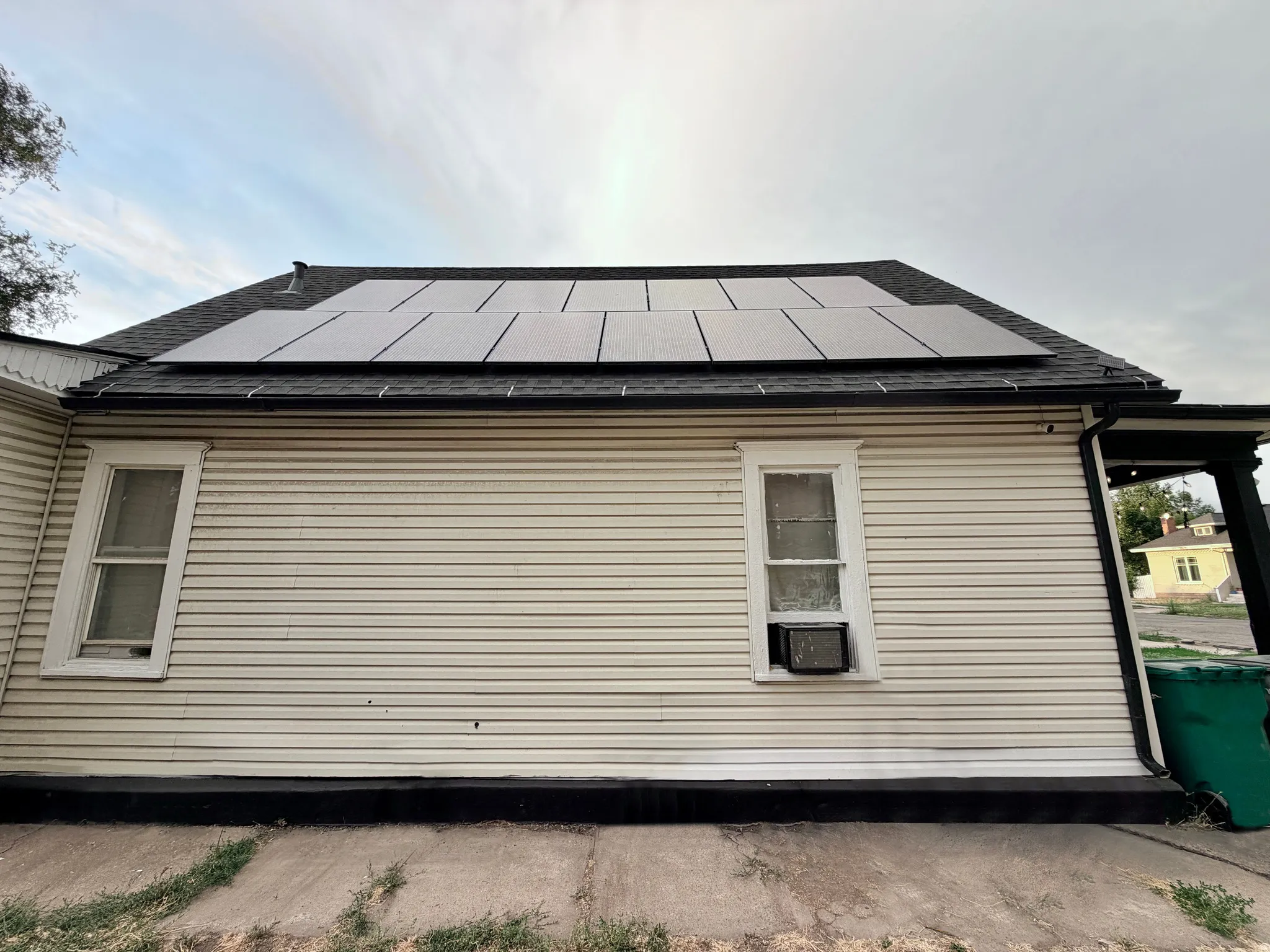 Roofline featuring multiple solar panels and dark shingles