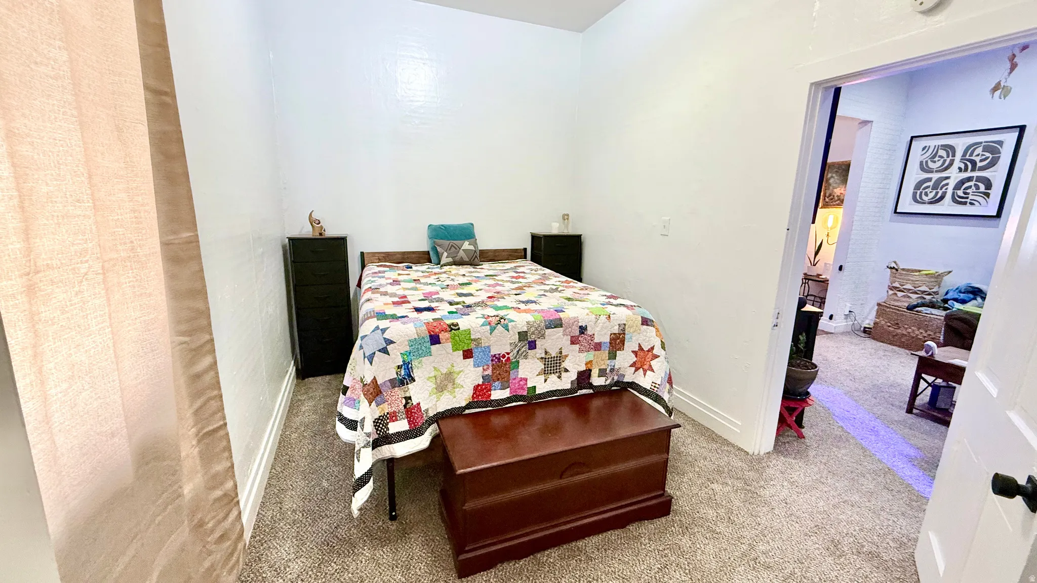 Carpeted room with white walls and baseboards