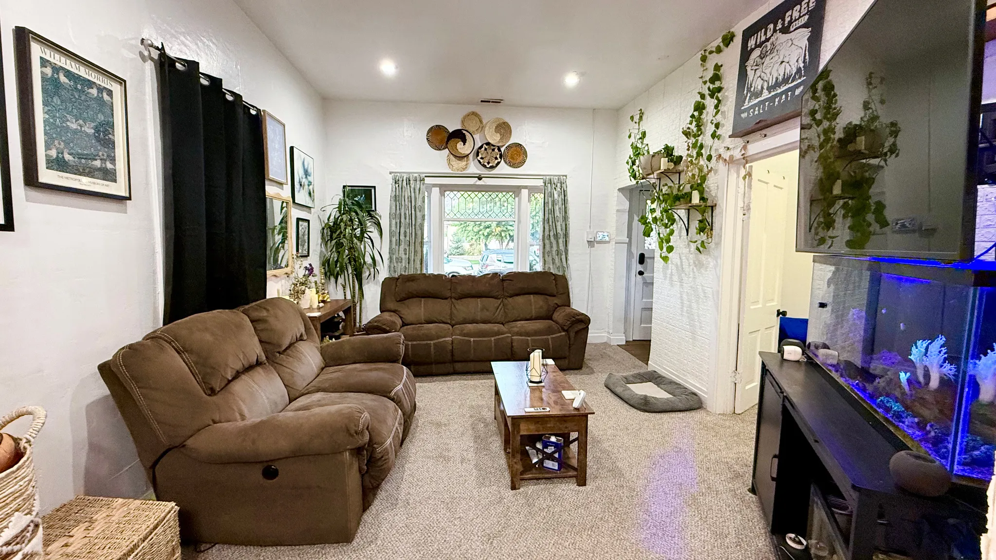 Spacious living area featuring light-toned carpeting and recessed lighting