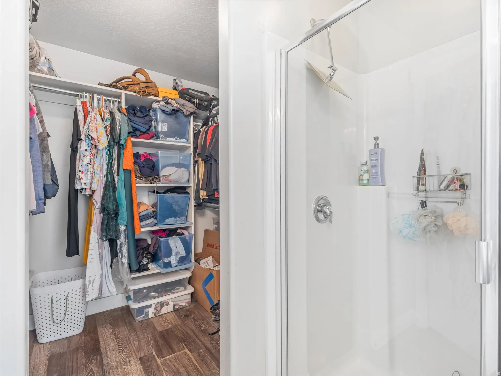 Walk-in shower with clear glass enclosure and chrome fixtures