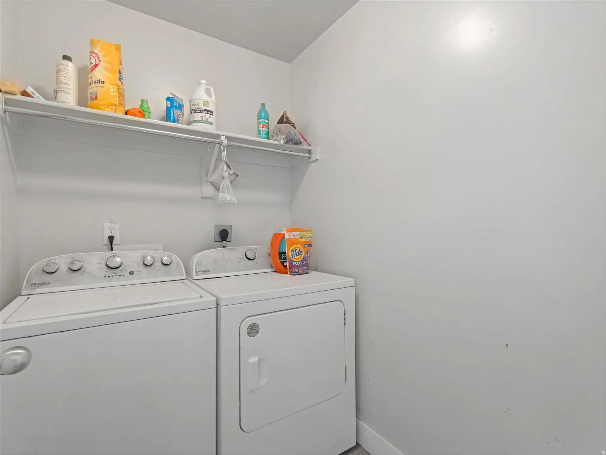 Dedicated laundry area featuring a white top-load washing machine and a white front-load dryer