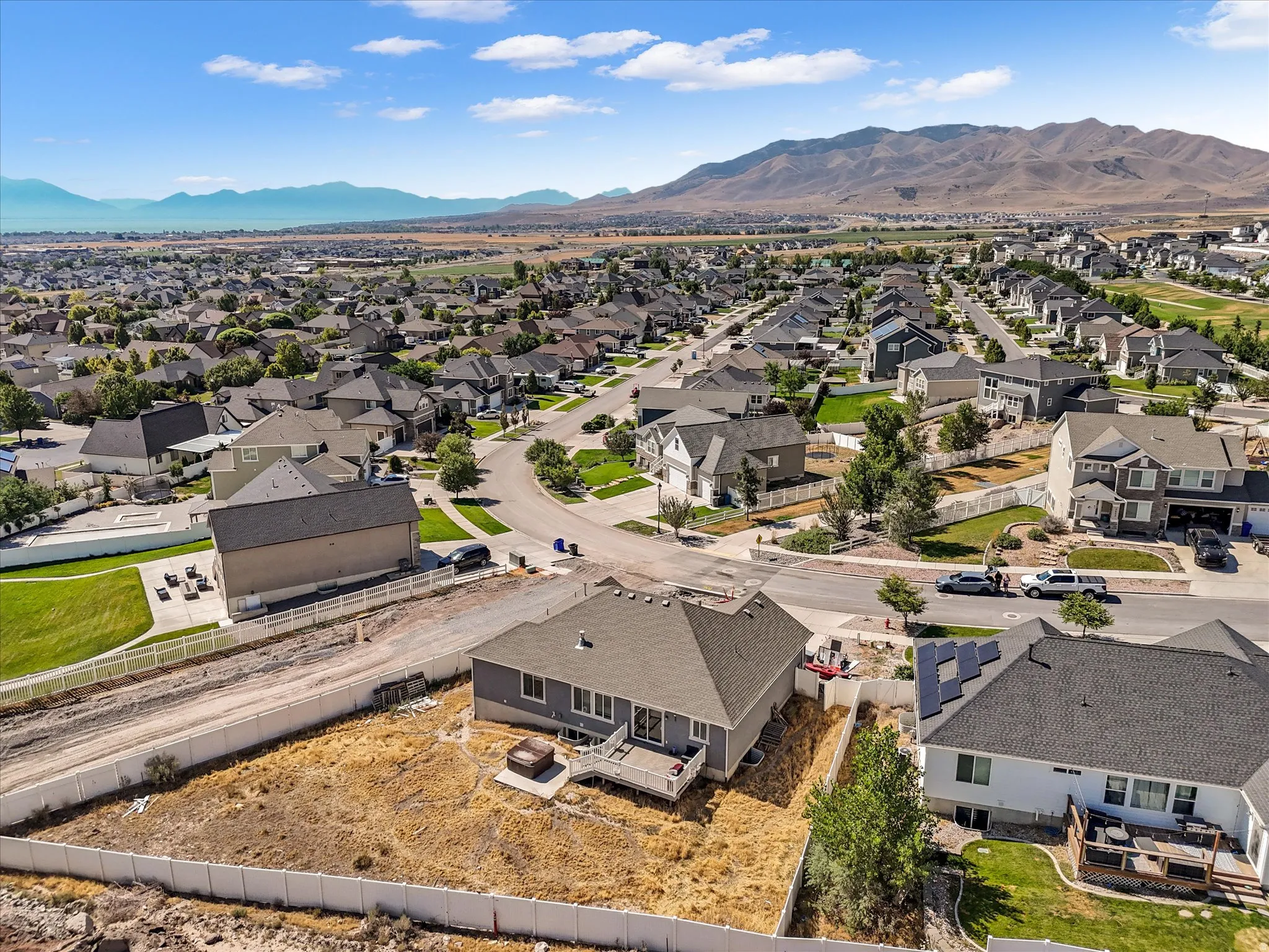 Residential neighborhood featuring single-family homes with mountain and distant water scenery