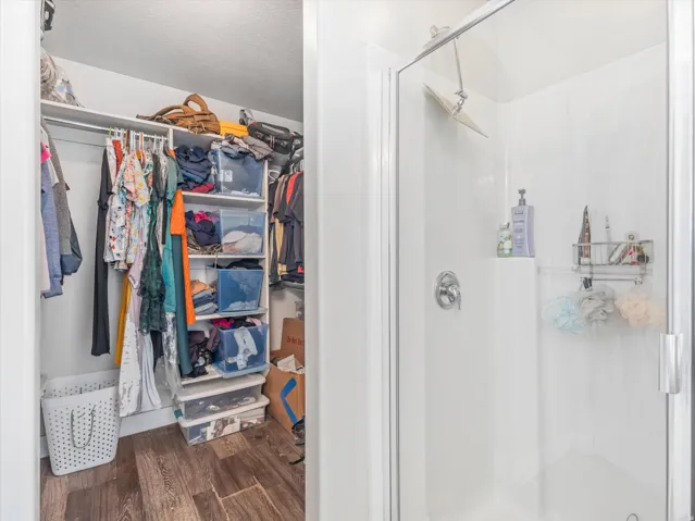 Walk-in shower with clear glass enclosure and chrome fixtures