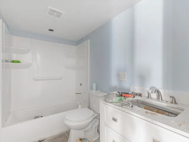 White vanity with a neutral countertop and chrome fixtures
