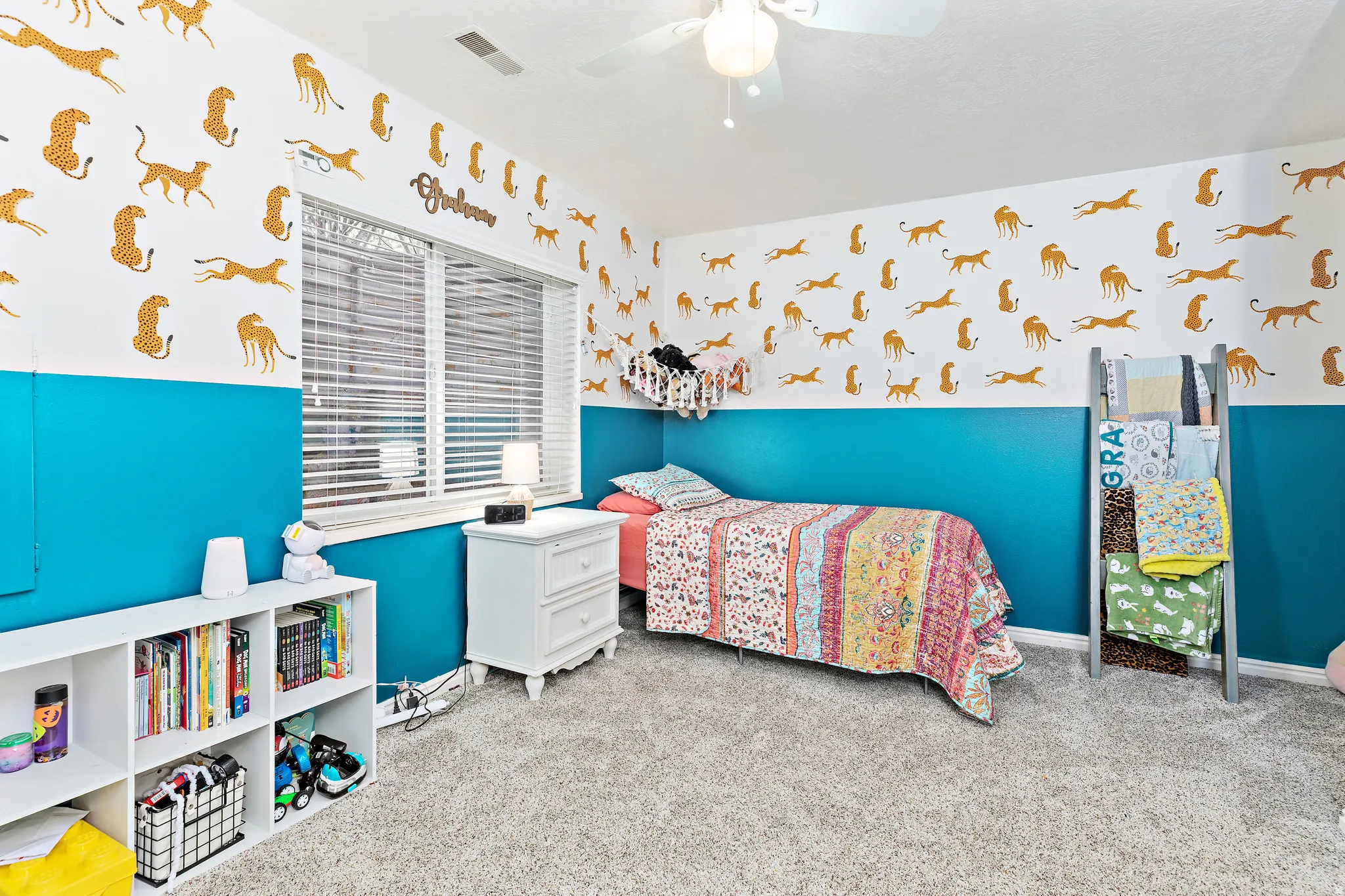 Carpeted room featuring a ceiling fan with light, a window with blinds, and white painted trim