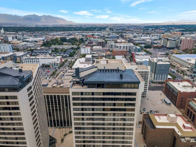 Cityscape featuring multiple high-rise buildings and a distant mountain range