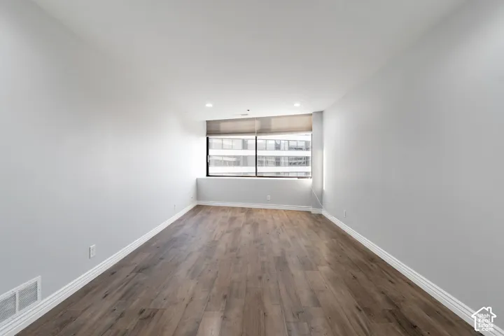 Spacious primary bedroom with laminate flooring
