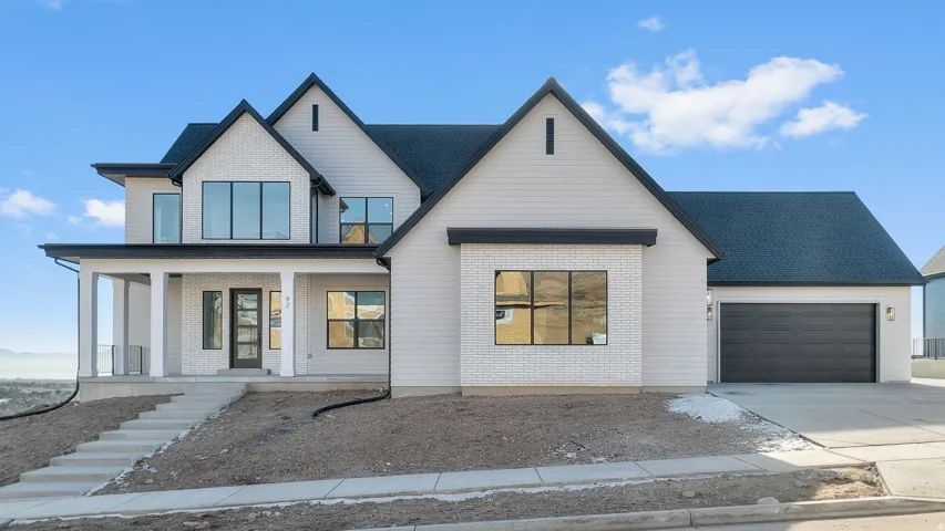 Contemporary exterior featuring white brick accents and light siding