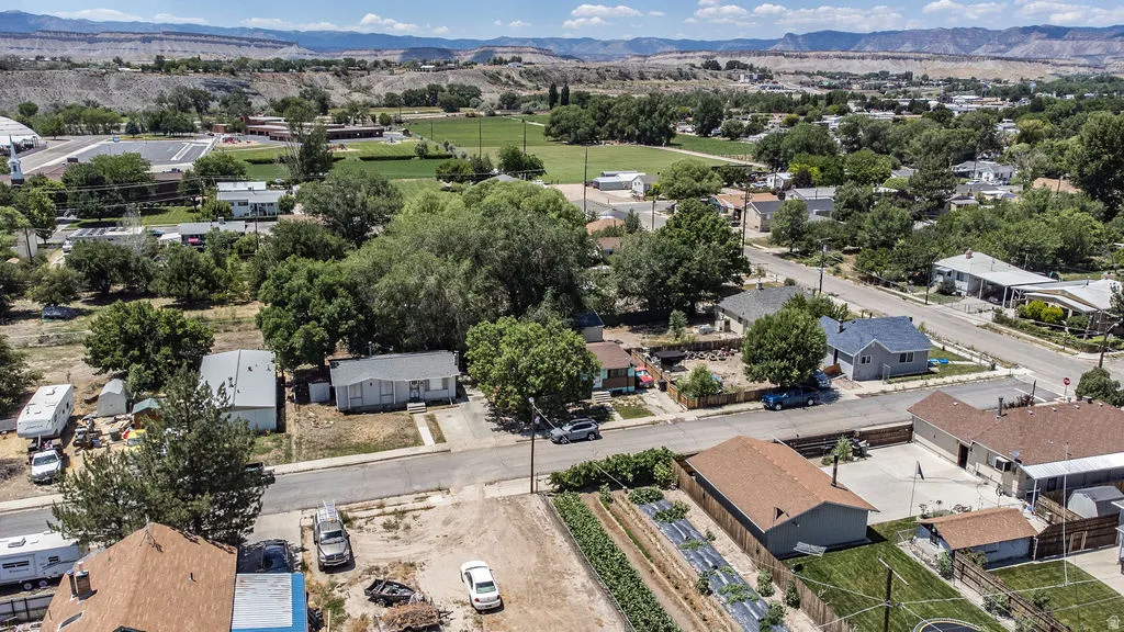 Aerial perspective showcasing a neighborhood setting with established trees and residential structures