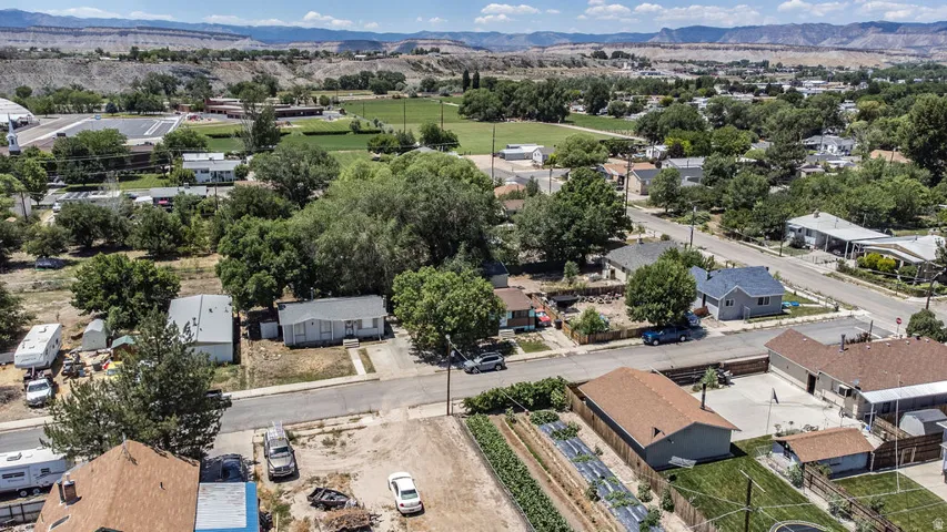 Aerial perspective showcasing a neighborhood setting with established trees and residential structures