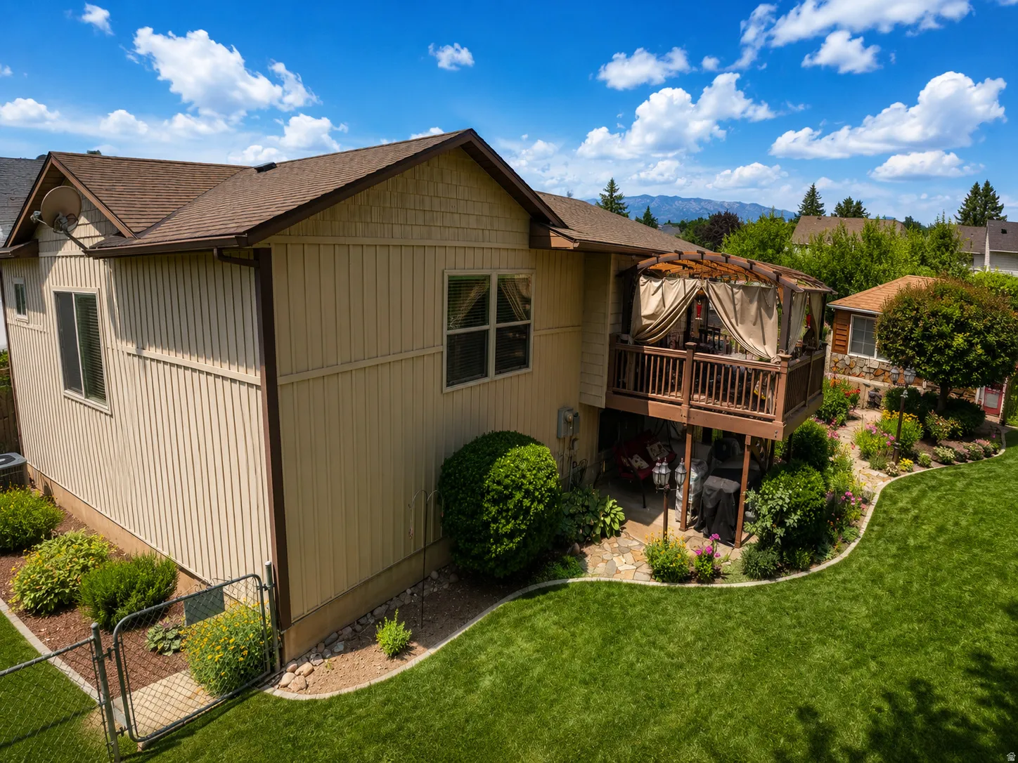 Two-story property with a brown shingle roof and vertical siding