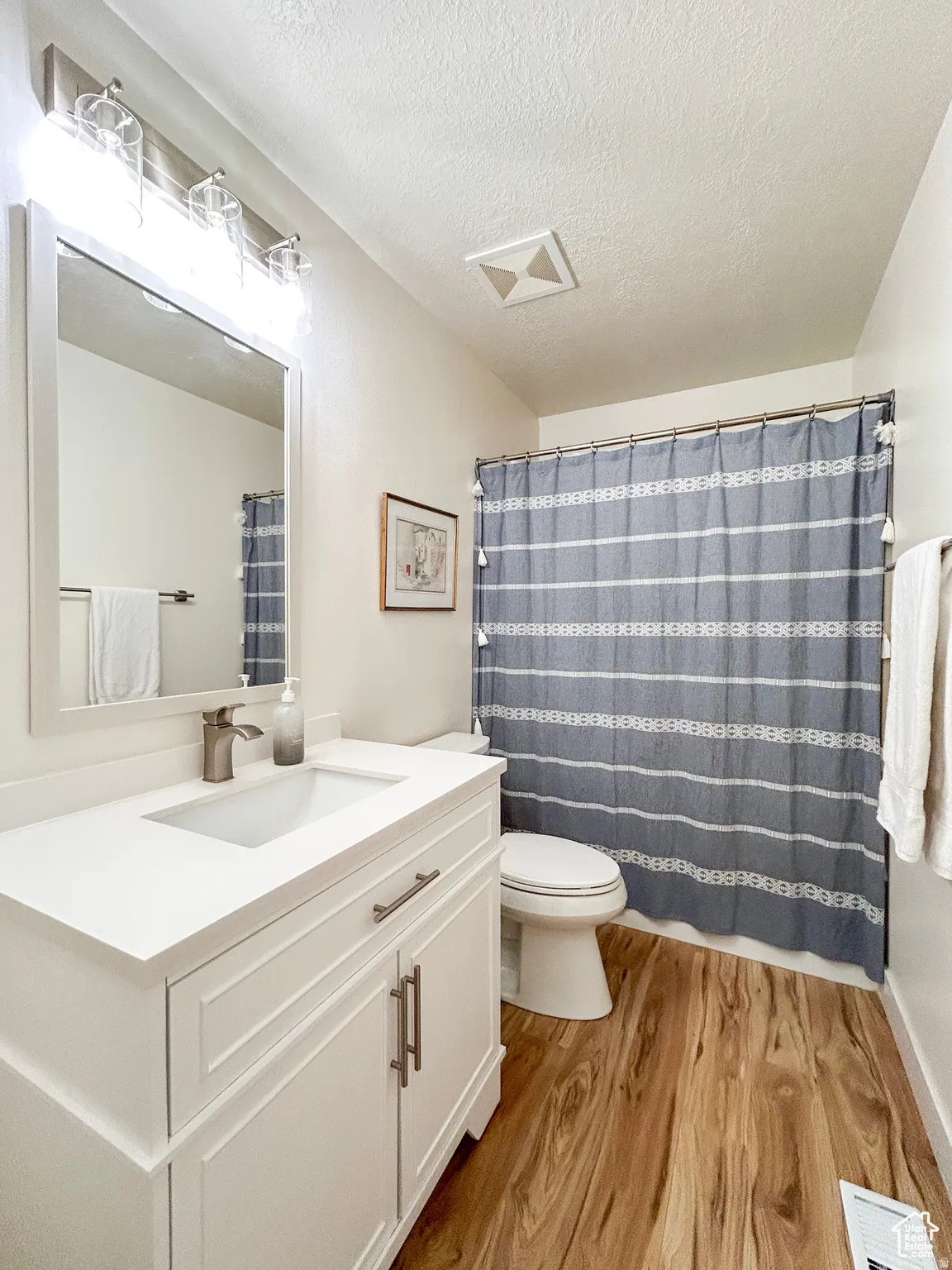White single vanity with integrated sink and brushed nickel faucet