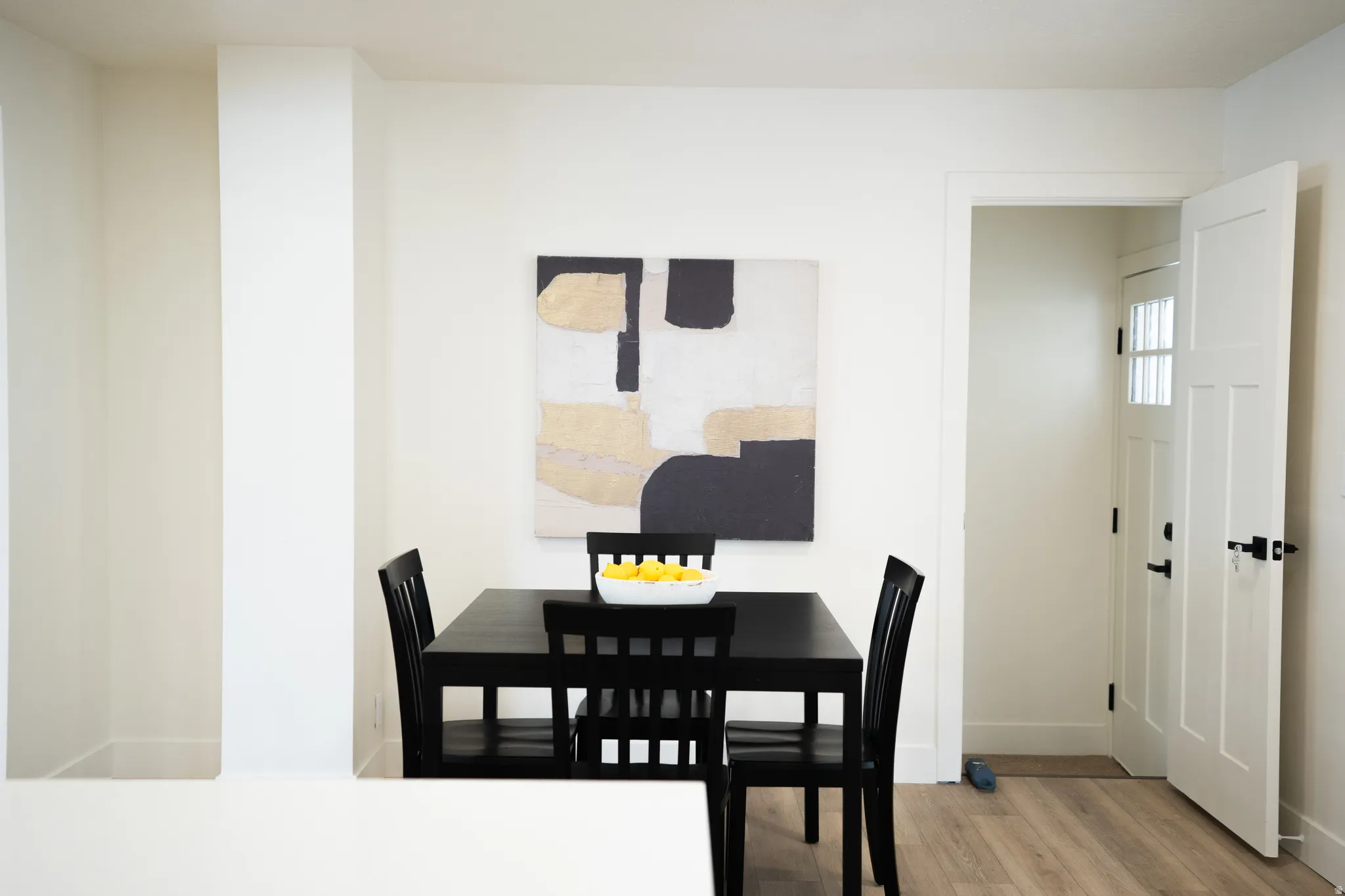 Open doorway featuring a paneled door with frosted glass inserts and matte black hardware