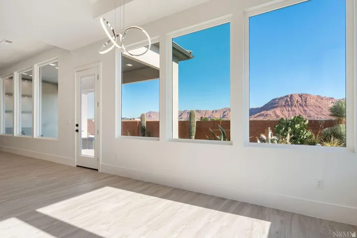 Expansive windows framing mountain and desert landscaping