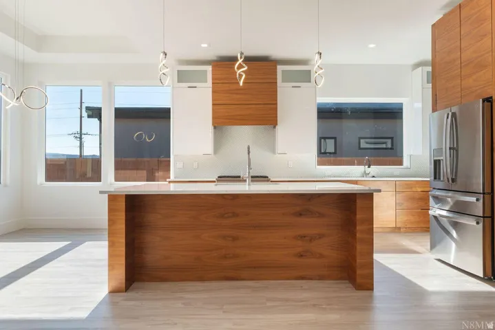 Modern kitchen featuring a wood-finish island with a light-toned countertop