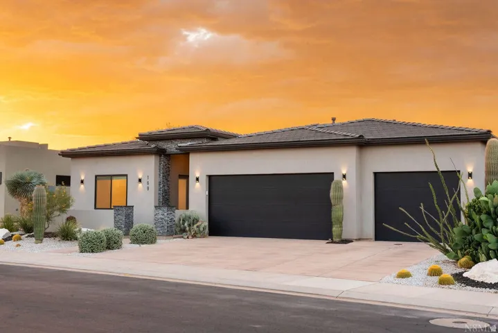 Modern stucco exterior with stone accents and desert landscaping