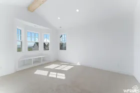 Bright room featuring a prominent bay window with an integrated built-in bench and shelving