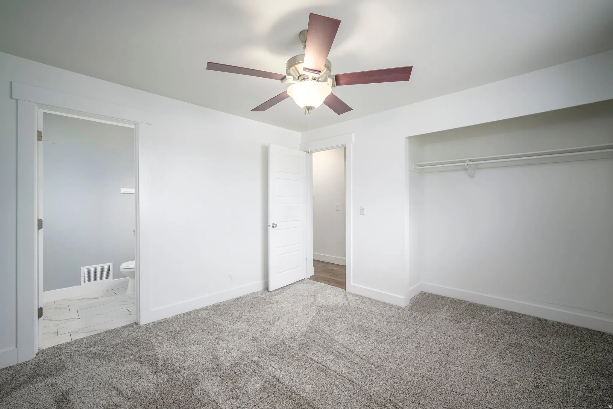 Neutral wall tones paired with soft grey carpeting
