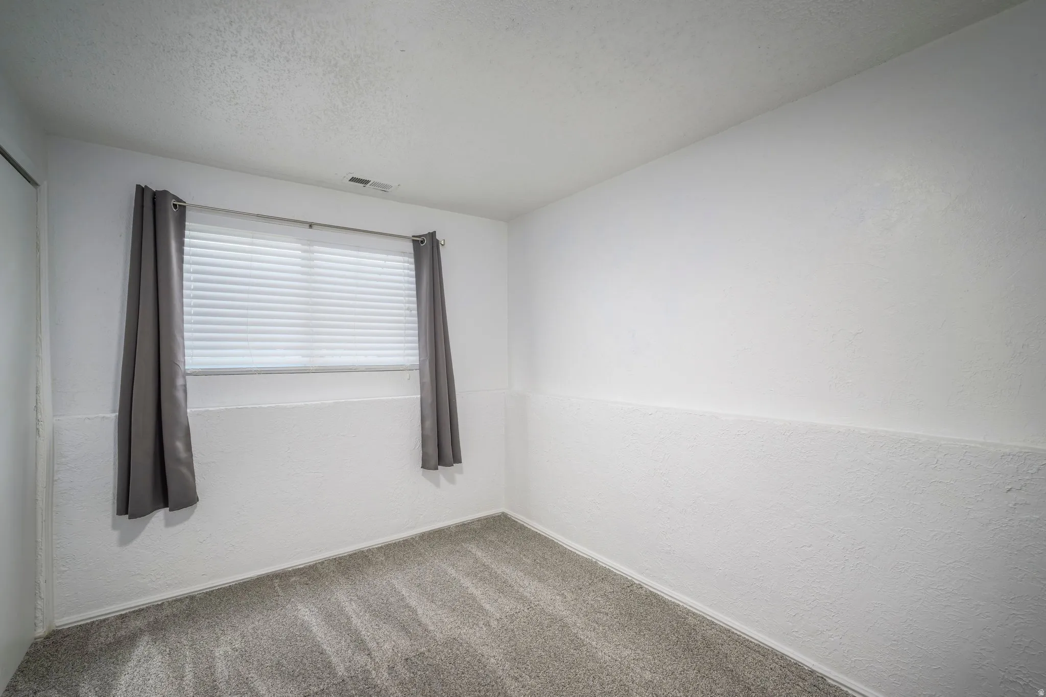 Light gray carpeting complementing white walls