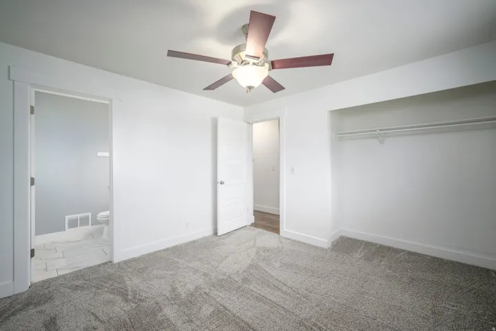 Neutral wall tones paired with soft grey carpeting