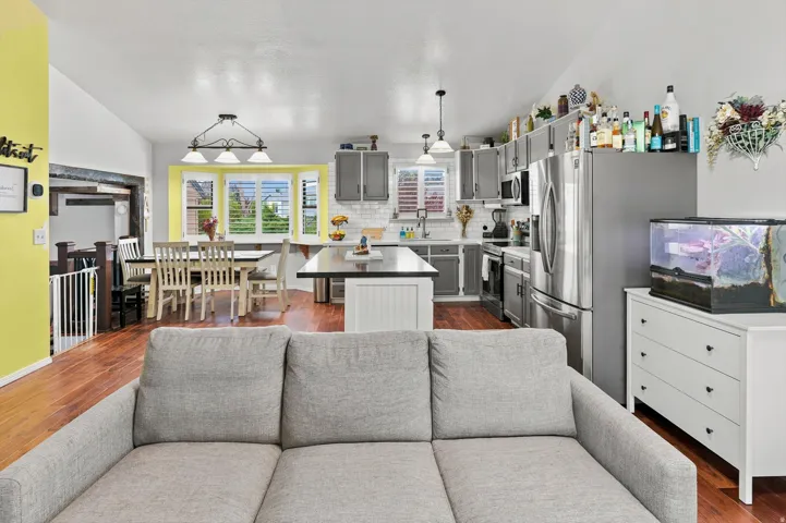 Open concept living area featuring wood-finish flooring