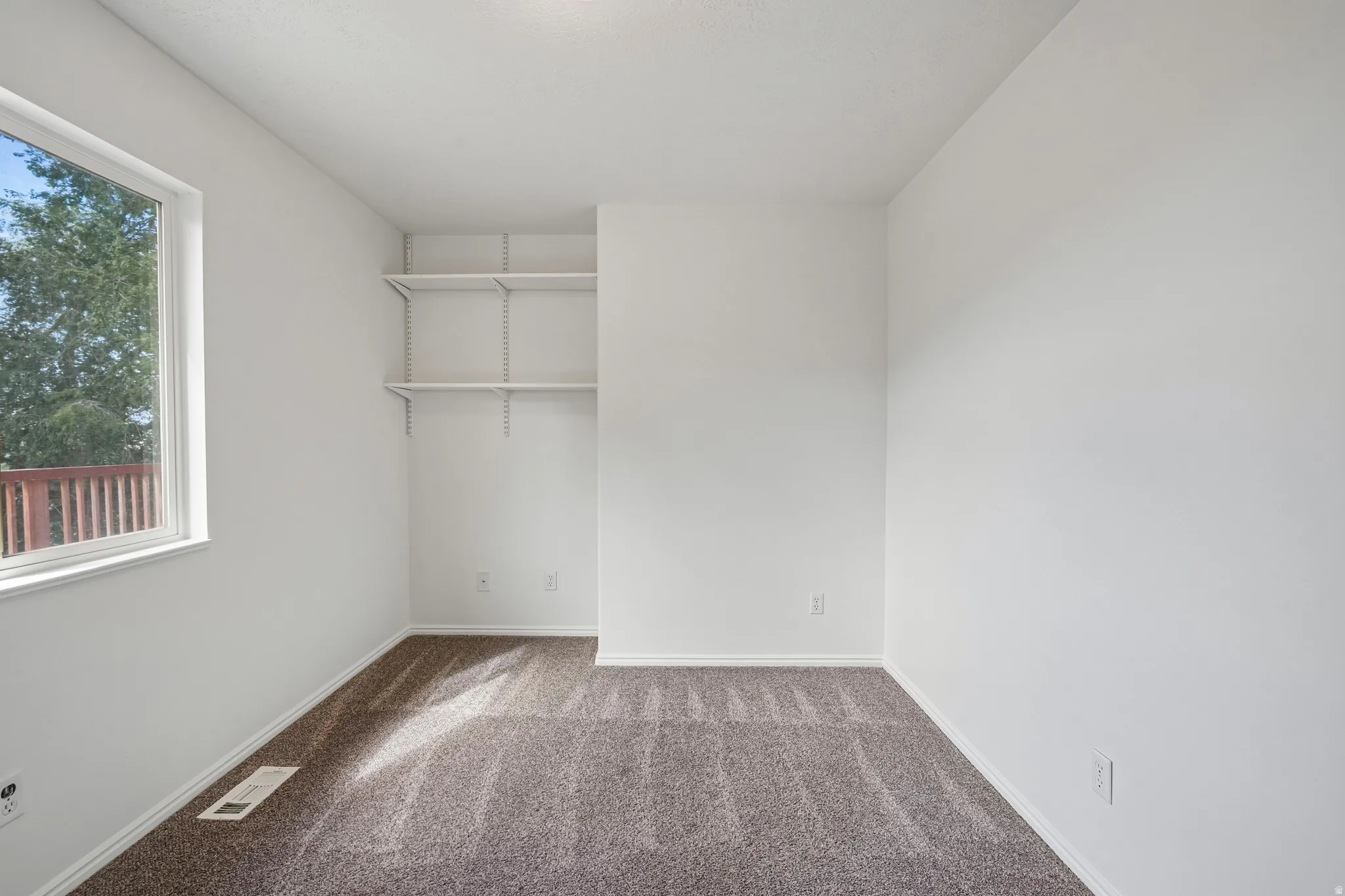 Neutral-toned carpeting complements the white walls and trim