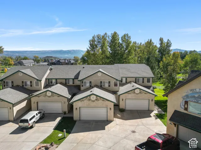 Stucco exterior with decorative trim, 2-car garage second from the right, and a paved driveway